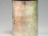 a silver cup that is sitting on a table