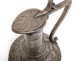 a silver vase with a metal handle on a white background