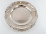 an antique silver plate on a white table with a white background