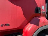 a red semi truck with a red cab parked in a parking lot