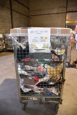 a metal cart with many items in it in a warehouse