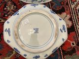 three plates with blue and white designs are sitting on a rug