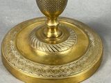 a gold plate with a gold vase on it