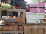 a pile of luggage sitting on top of a cardboard box