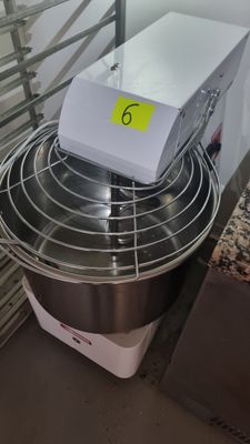 a box sitting on top of a mixer in a kitchen