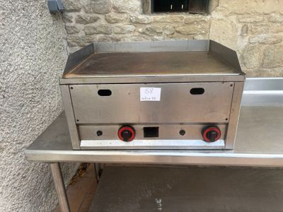 stainless steel counter top with two red knobs on it