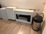 a picture of a kitchen with a trash can and cabinets