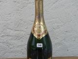 a bottle of champagne sitting on a wooden table