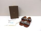 sandals are on a table next to a box and a card