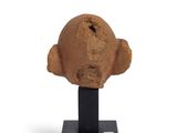 sculpture of a head on a black stand on a white background