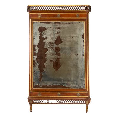 une image représentant un miroir accroché au mur, dont la surface est rouillée
