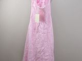 pink dress hanging on a hanger against a white wall
