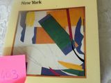 a picture of a book on a table with a pink post it