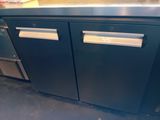 a picture of a stainless steel counter top with two doors