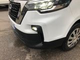 the front end of a white van parked on the side of the road