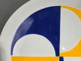 a white plate with a yellow and blue design on it