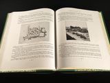 an open book with a picture of a house on it
