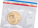 a close up of a coin in a plastic bag on a white background