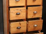 a wooden chest of drawers with many drawers on it
