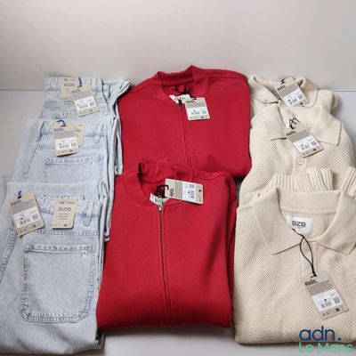 three pairs of men ' s sweaters sitting on top of a white table