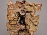 an image of a sculpture of a man on a rock with a hammer