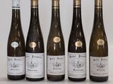 six bottles of wine are lined up on a table