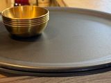 an image of a plate with a gold cup on it