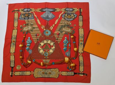 an image of a red scarf with a design on it and an orange box