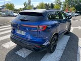 a blue car that is parked on the side of the road