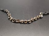 a close up of a metal chain on a black surface