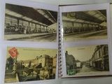 a hand holding an open book with pictures of a train station