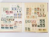un livre ouvert, orné de timbres, posé sur une surface blanche