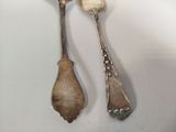 two spoons that are sitting on a table