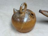 two brown vases sitting next to each other on a table