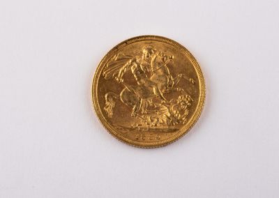 a gold coin on a white surface with a white background