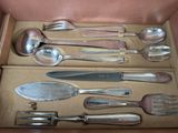 a lot of silverware in a box on the table