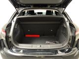the back of a car with its trunk open and a red object in the trunk