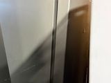 an image of a stainless steel refrigerator in a room