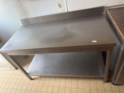a stainless steel table in a kitchen with a granite counter top