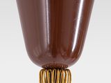 a chocolate cup on a wooden stick with a ring around it