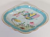 a blue and white bowl with a bird design on it