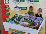 two children playing with a big train set in the box