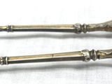 two spoons that are sitting on a table