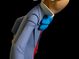 a figurine of an old man in a suit and tie