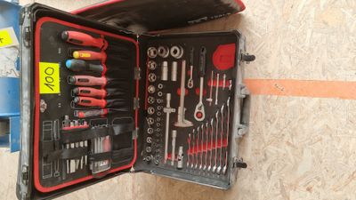 a tool case with tools in it sitting on the floor