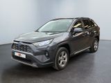 a grey toyota rav parked in a room with a black floor
