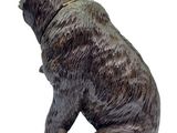 a statue of a bear sitting on a white surface