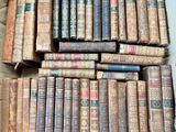 a lot of old books in a box on the floor