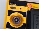 a yellow and black electronic device sitting on a table