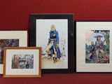 a lot of framed art on the wall in this room